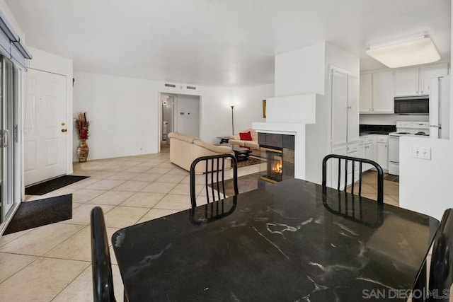 tiled dining area with a tile fireplace