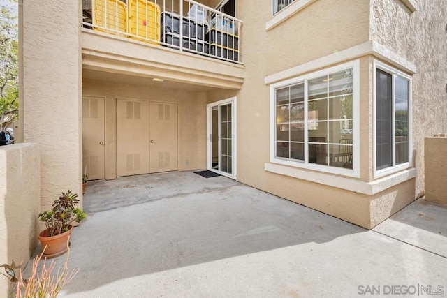 doorway to property featuring a balcony and a patio area