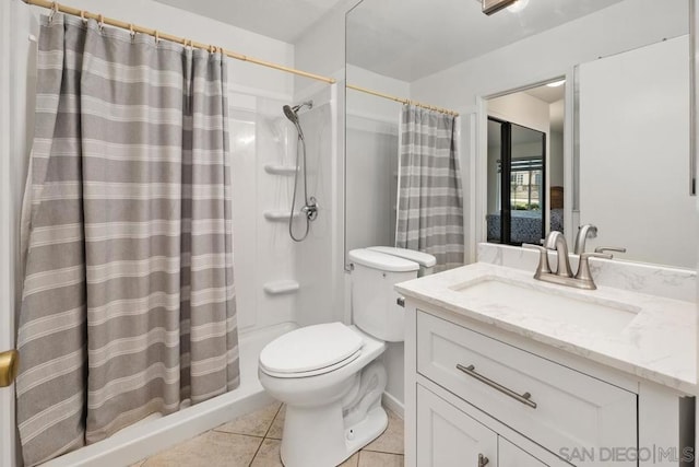 bathroom with vanity, a shower with curtain, tile patterned floors, and toilet