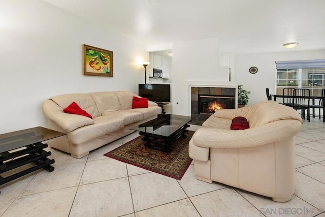 living room featuring light tile patterned floors and a fireplace