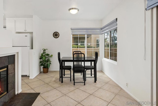 tiled dining area featuring a tiled fireplace