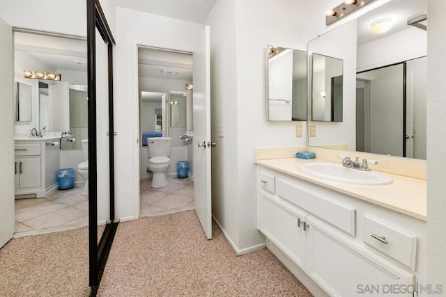 bathroom featuring vanity, toilet, and tile patterned flooring