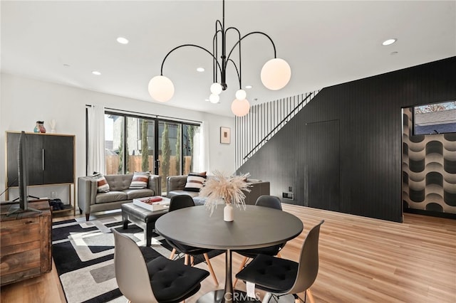 dining room with light wood-type flooring, stairway, and recessed lighting