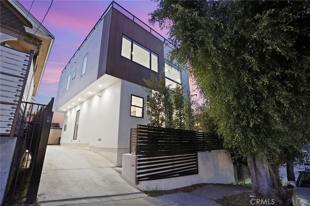 view of property exterior featuring fence and stucco siding