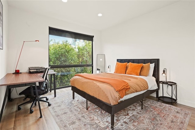 bedroom featuring light wood-style flooring, baseboards, and recessed lighting