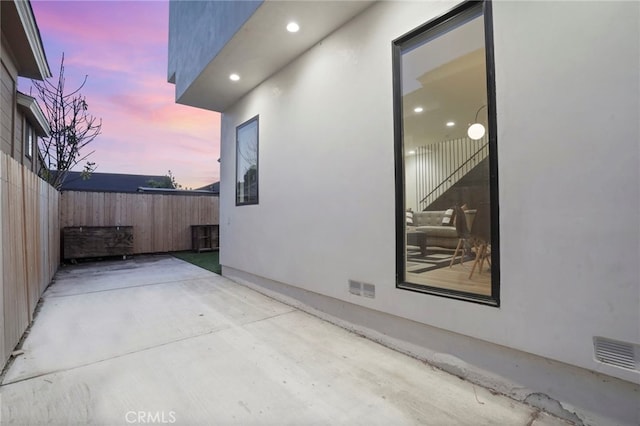 view of patio / terrace featuring fence and visible vents