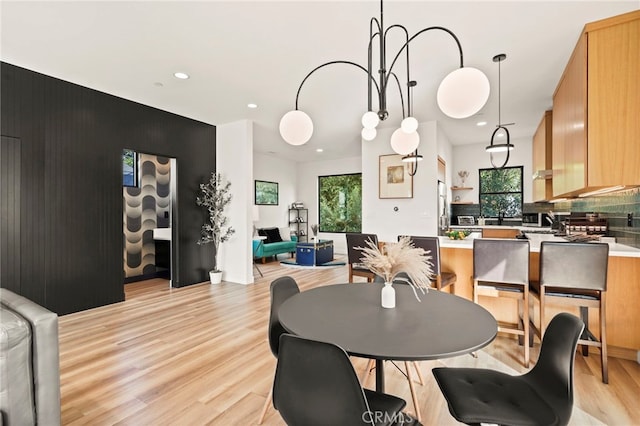 dining space featuring light wood finished floors and recessed lighting