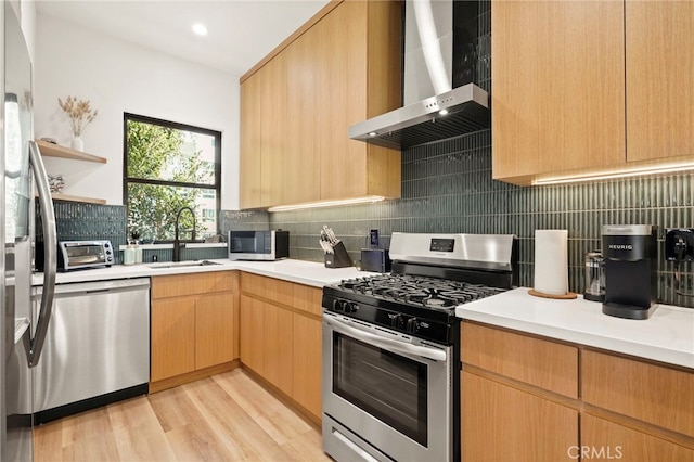 kitchen with open shelves, backsplash, appliances with stainless steel finishes, a sink, and wall chimney range hood