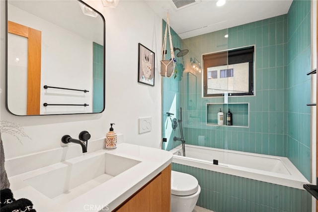 full bath with toilet, tiled shower / bath combo, visible vents, and vanity