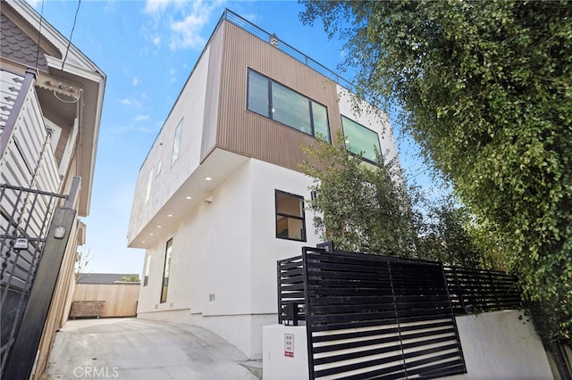 exterior space featuring stucco siding, fence, and a patio