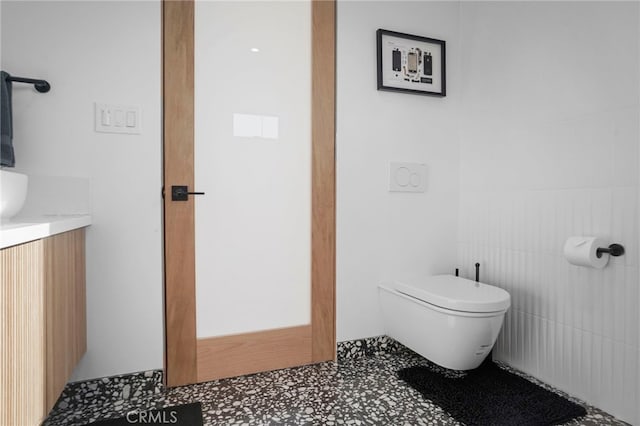 bathroom featuring toilet and vanity