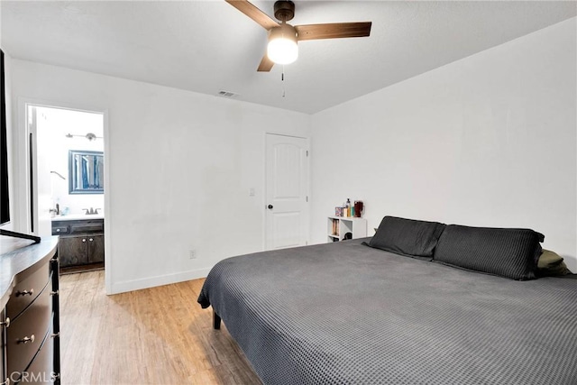 bedroom featuring ceiling fan, connected bathroom, visible vents, baseboards, and light wood-style floors