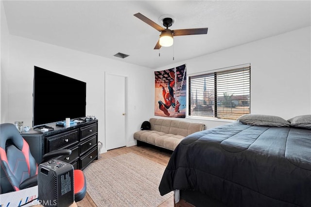 bedroom with visible vents, ceiling fan, and light wood-style flooring