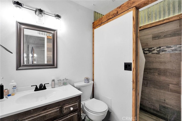 bathroom featuring toilet and vanity