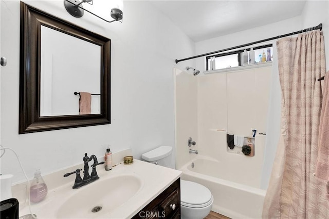 bathroom with shower / tub combo, vanity, and toilet