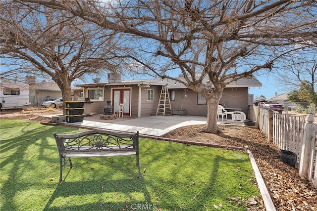 back of house featuring a patio, a yard, fence, and french doors