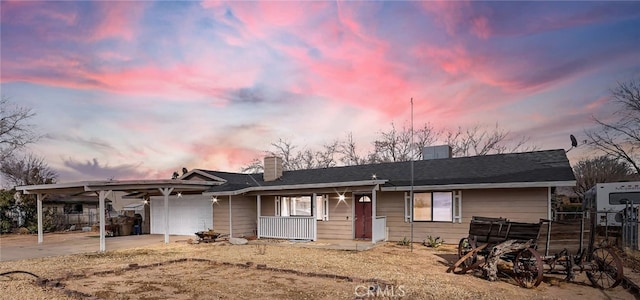 single story home with a garage, concrete driveway, covered porch, and a chimney