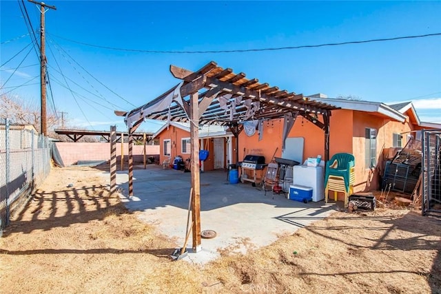 view of patio featuring washer / dryer and a pergola