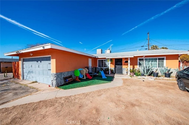 ranch-style home featuring a garage