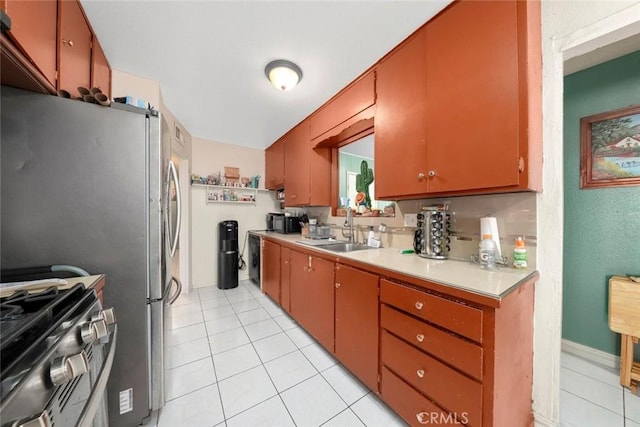 kitchen with light tile patterned flooring, appliances with stainless steel finishes, and sink