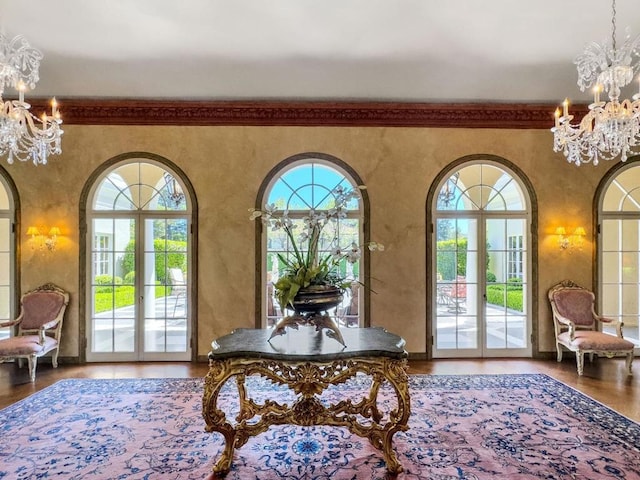 foyer entrance with an inviting chandelier, a wealth of natural light, and french doors