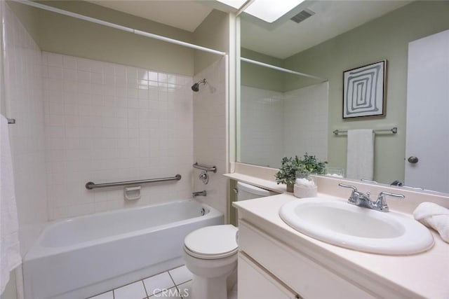 full bathroom featuring tile patterned floors, vanity, toilet, and tiled shower / bath