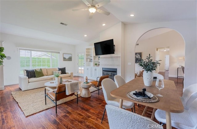 living room featuring dark wood-type flooring, high vaulted ceiling, and ceiling fan