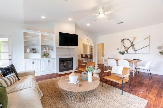 living room with vaulted ceiling, dark wood-type flooring, and ceiling fan