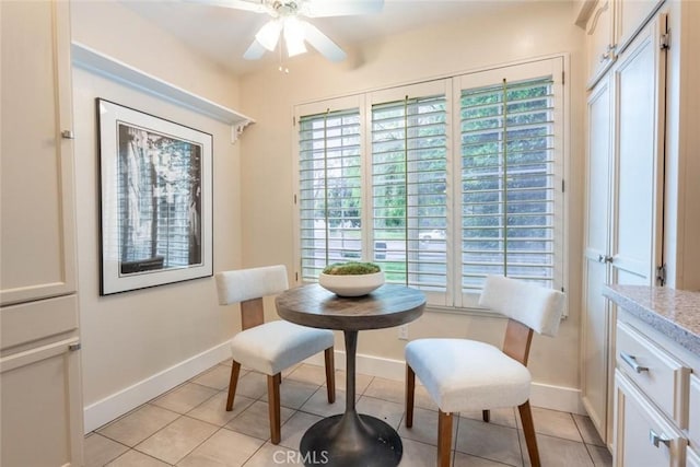 living area featuring plenty of natural light, light tile patterned floors, and ceiling fan