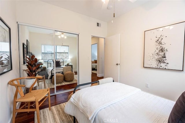 bedroom with wood-type flooring and a closet