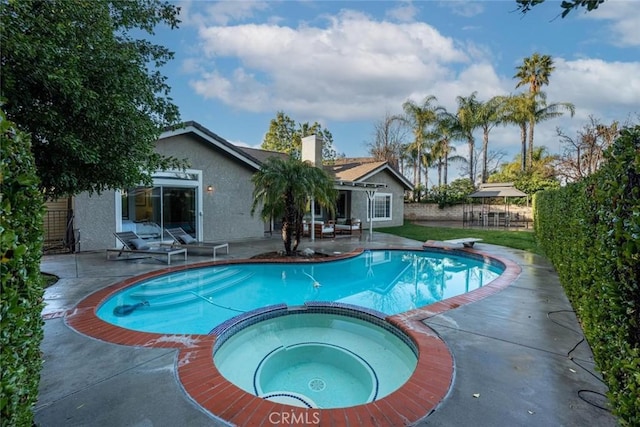 view of pool featuring a patio area, a diving board, and an in ground hot tub