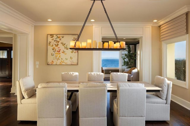 dining area featuring a water view, ornamental molding, and dark wood-type flooring