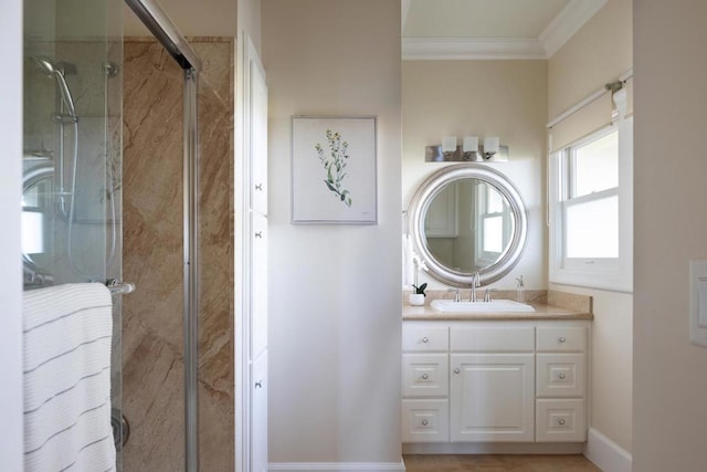 bathroom featuring vanity, a shower with door, and ornamental molding