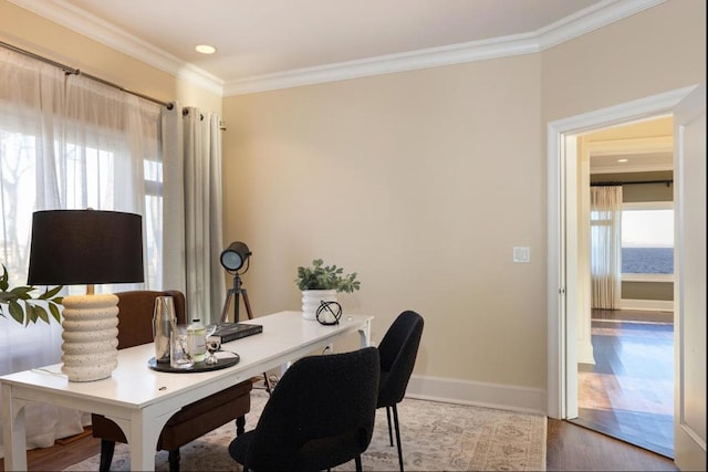 home office featuring hardwood / wood-style floors, crown molding, and a wealth of natural light