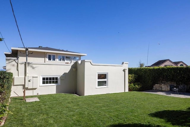 rear view of property with a yard