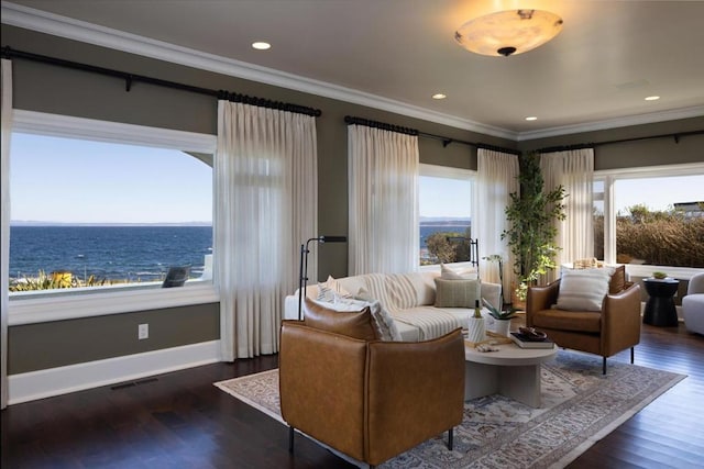 living room with a water view, ornamental molding, and dark wood-type flooring