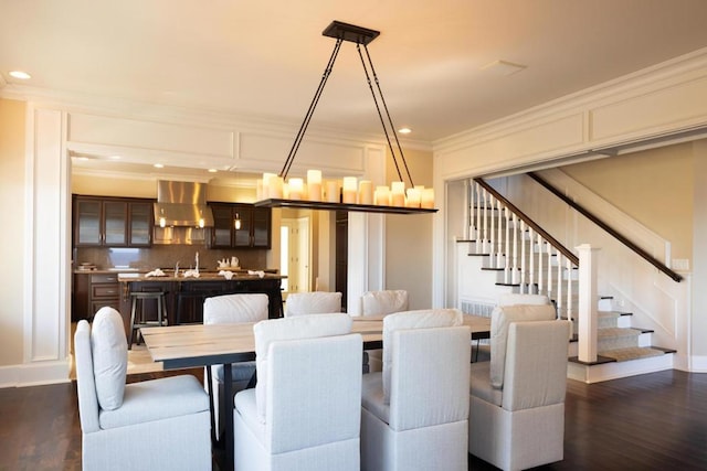 dining area with ornamental molding and dark hardwood / wood-style flooring