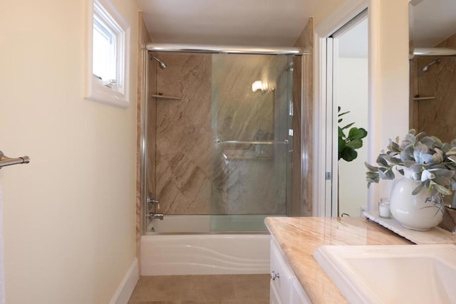 bathroom with vanity and shower / bath combination with glass door