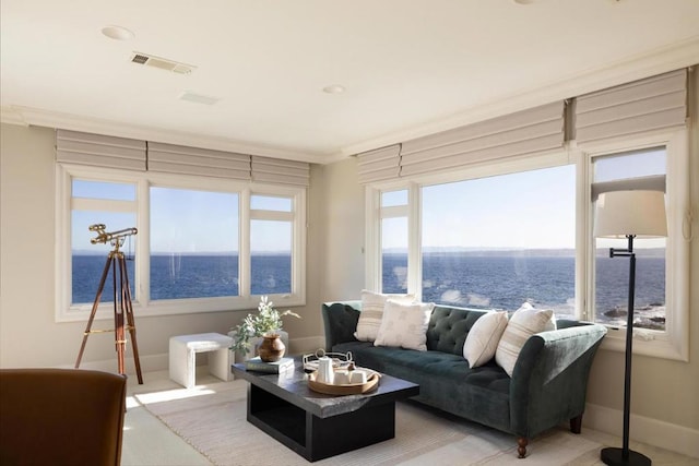 living room featuring crown molding and a water view