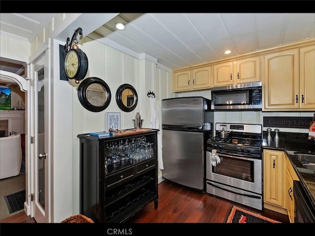 kitchen featuring light brown cabinetry, ornamental molding, stainless steel appliances, and dark hardwood / wood-style floors