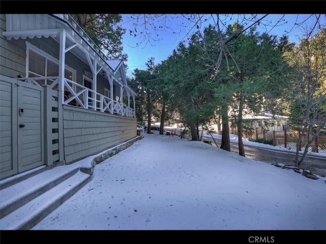 view of yard layered in snow