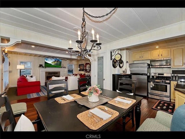 dining area featuring ornamental molding, dark hardwood / wood-style floors, and a chandelier