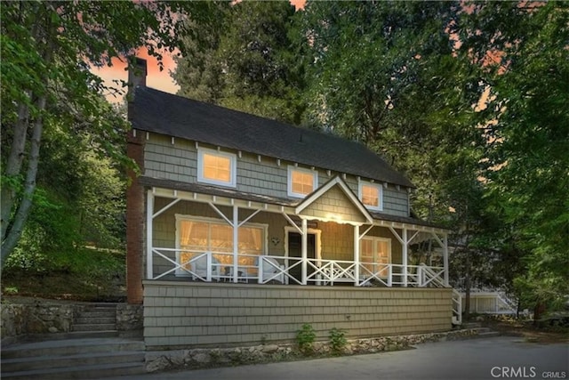 855 Lake Dr, Lake Arrowhead, CA 92352 - view of front of property with covered porch and a chimney