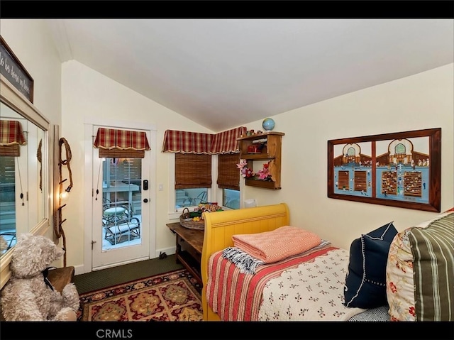 carpeted bedroom featuring vaulted ceiling and access to outside