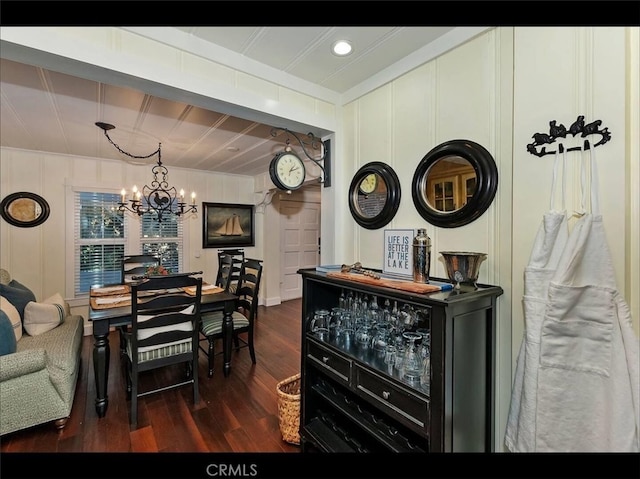 dining area featuring dark wood-type flooring and a chandelier