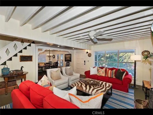 living room with ceiling fan with notable chandelier and beamed ceiling