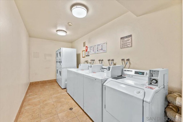 laundry room with light tile patterned floors and washing machine and clothes dryer