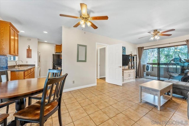 tiled living room with sink and ceiling fan