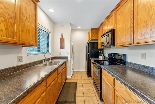 kitchen with sink, light tile patterned floors, and black appliances