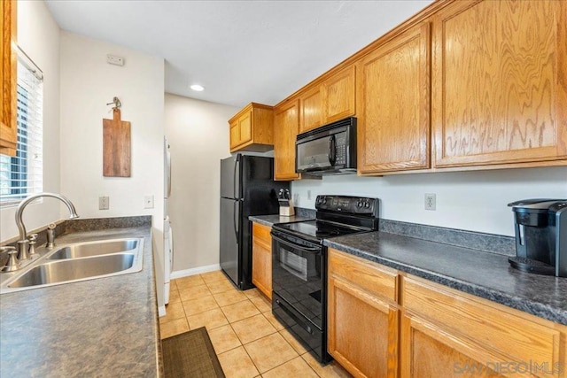 kitchen with sink, light tile patterned floors, and black appliances